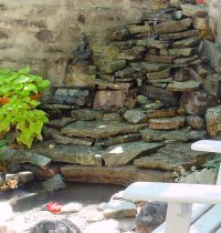 Native stone from a quarry near Helena adds a Montana touch to this backyard pool, which is fitted with a solar-powered fountain.